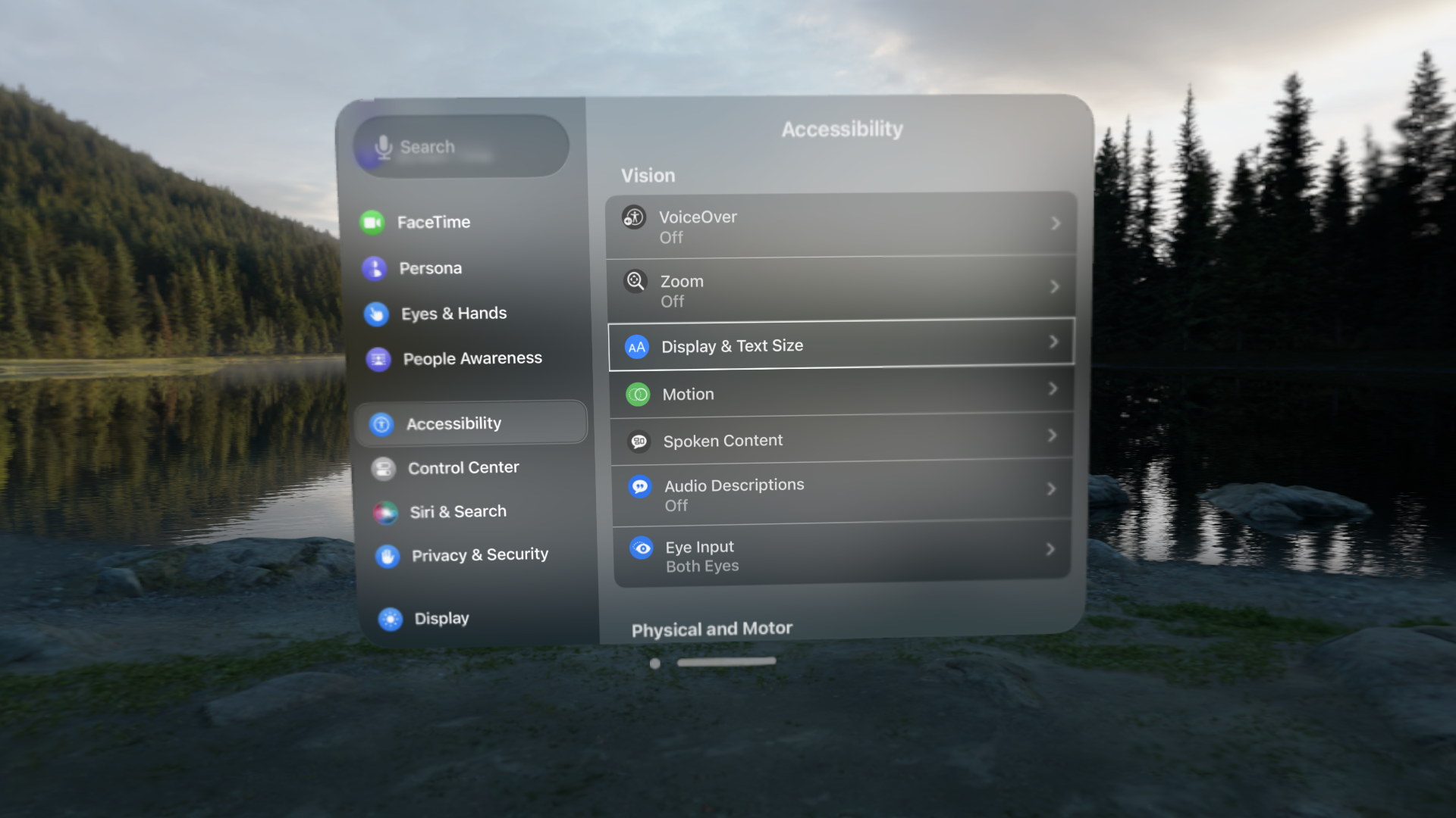 A screenshot of the Accessibility settings in visionOS. Options can be seen in the Vision heading for VoiceOver, Zoom, Display and Text Size, Motion, Spoken Content, Audio Descriptions (set to off), and Eye Input (set to Both Eyes). A Physical and Motor heading is visible at the bottom of the window, hinting at scrollable content.